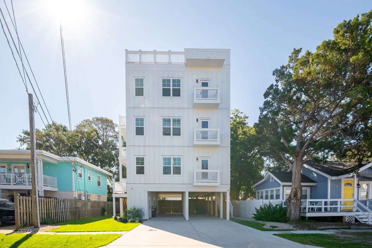 A modern duplex exterior featuring inviting balconies and lush greenery, with ample space for residents to enjoy fresh air and outdoor gatherings. The architecture is contemporary and welcoming, hinting at the comfort and convenience inside.